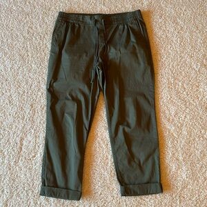 Green Old Navy pants with cuffed bottoms